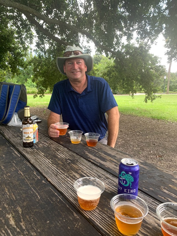 IMG_2339 a man sitting at a picnic table