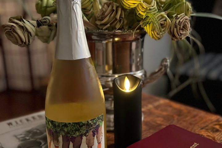 a glass of wine sitting on top of a table