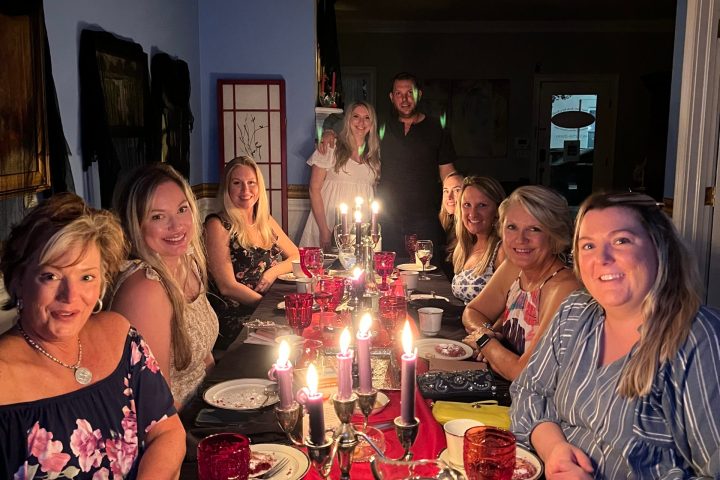 a group of people sitting at a table posing for the camera