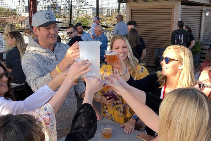 Vinnie Pestano et al. holding glasses of beer