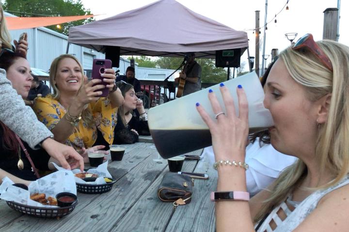 a group of people sitting at a picnic table
