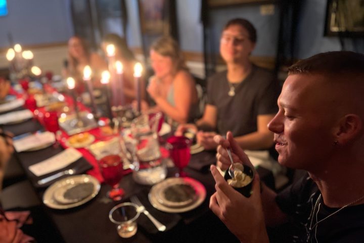 a group of people sitting at a table with wine glasses