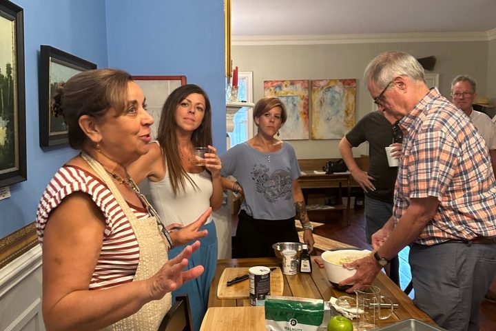 a group of people standing around a table